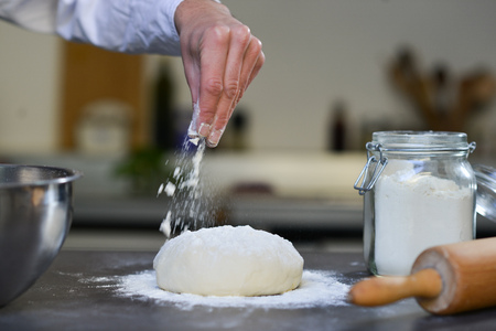 Chef preparing dough in kitchen flour douth Pizzaの写真素材