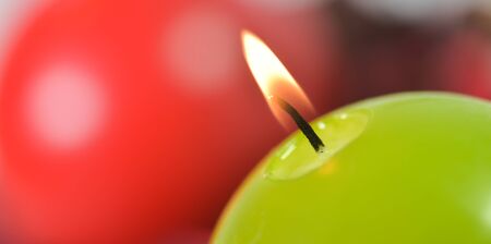 Burning candles Green and red candles studio shootの写真素材