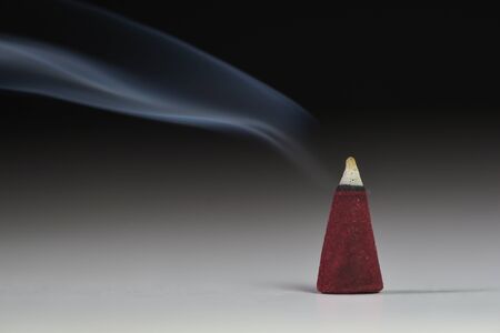 Incense stick with smoke on  black backgroundの写真素材