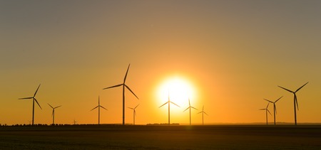 Windwheels and a beautiful sunset seen in rural France, Europe