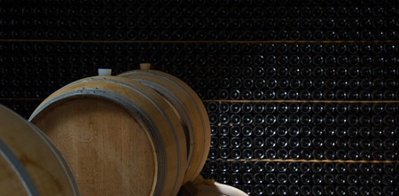 Underground wine cellar, Wooden barrels, bottles storage, Bordeaux Wineyardの写真素材