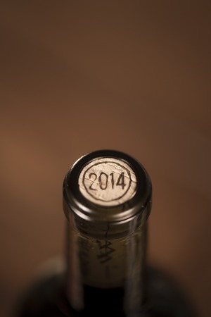 Close-up of closed wine bottles lying on blurry background, wineryの写真素材