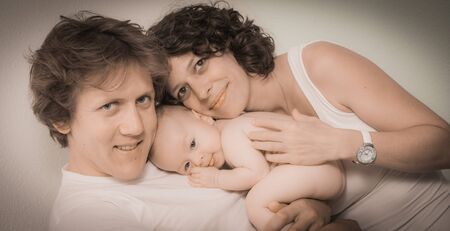 Happy mother and father with baby at home, Franceの写真素材