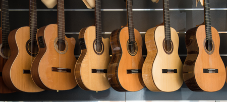 Many Classical Guitars Hanging on Wall in the Shopの写真素材