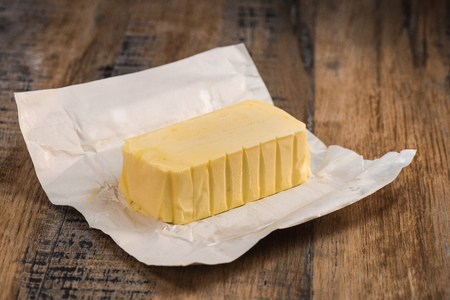 Butter on a wooden plate ready to eat. Food conceptの写真素材