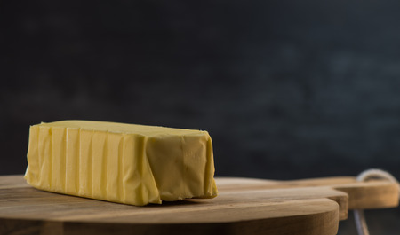 Butter on a wooden plate ready to eat. Food conceptの写真素材