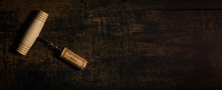 Vintage corkscrew with cork isolated on brown background, Franceの写真素材