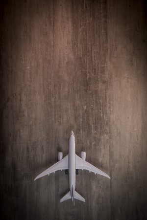 White blank toy of passenger plane on rustic wooden background, Travelの写真素材