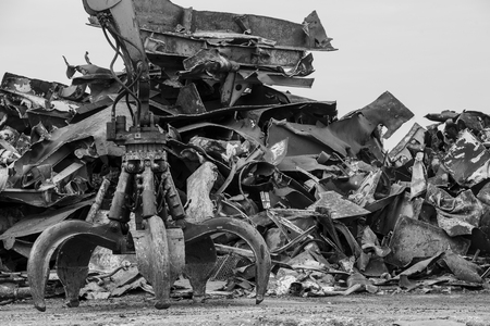 Large tracked excavator working a steel pile at a metal recycle yard, Franceの写真素材