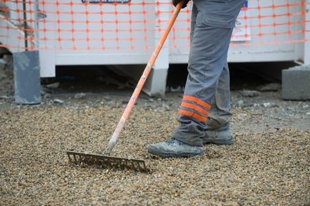 Construction worker sweeping on the building construction siteの写真素材