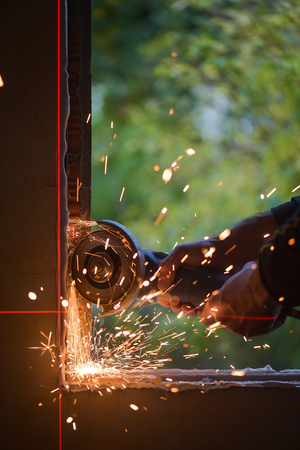 Window renovation-Metal grinding with orange flying sparksの写真素材