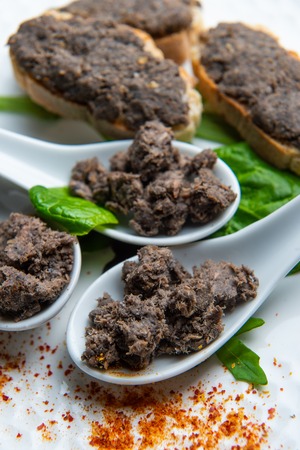Toast of lamprey pie with bordelaise on white spoonの写真素材