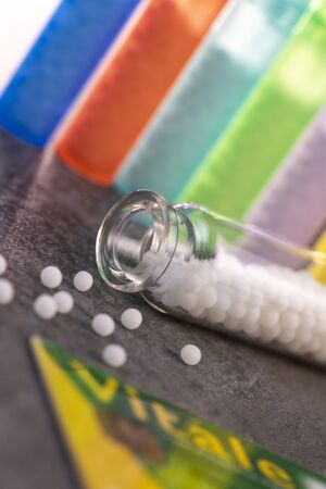 Modern Color homeopathic pills in plastic container on black background, Franceの写真素材