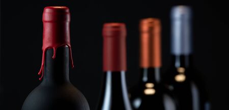 Set of collars red wine bottles isolated on black backgroundの写真素材