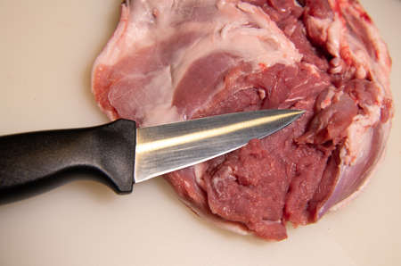Boning a shoulder of lamb leg meat on a wooden tray, white background, Top viewの写真素材