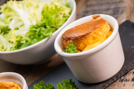 Cheese egg souffle on rustic cloth on a wooden backgroundの写真素材