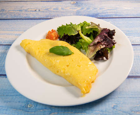 Omelette with salmon and herbs, served on plate, traditional Norwegian dishの写真素材