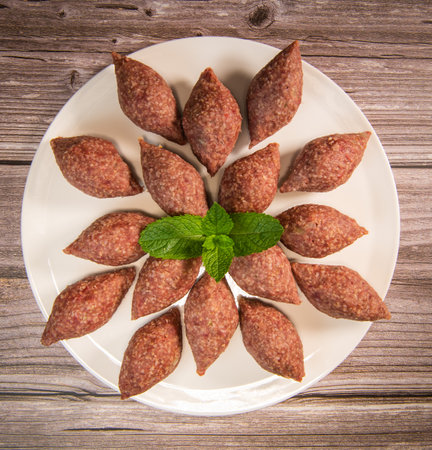 Traditional kebbe and pita bread on big round plate in lebanese restaurantの写真素材