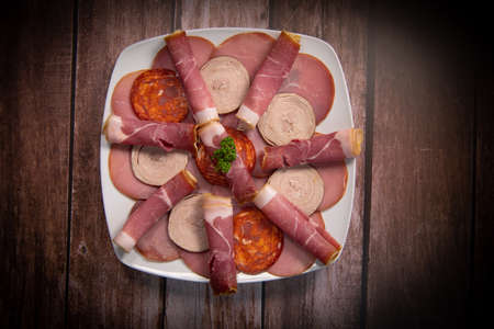 Food tray with delicious salami, pieces of sliced ham, sausage, Deli meats, Picklesの写真素材