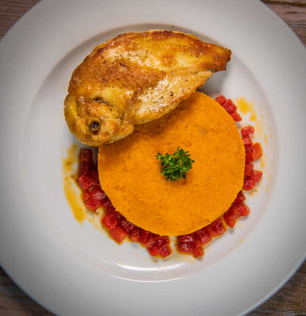 Chicken supreme recipe, gently cooked with 5 spices, sweet potato mousseline, peppers cut in halfの写真素材