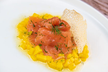 Recipe for salmon gravlax with mango brumoise and white balsamic vinegar dressingの写真素材
