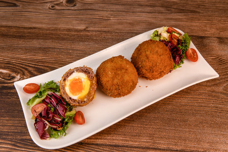 RECIPE FOR BREADED BEEF MEATBALLS STUFFED WITH A SOFT BOILED EGGの写真素材