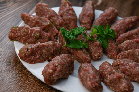 RECIPE FOR LEBANESE KEBBE NAYYHE, RAW MINCED BEEF, MARJORAM, MINT, ONIONS, CRUSHED WHEAT, SEVEN...