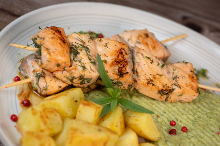 Barbecued salmon skewer with potatoes and broccoli Pureeの写真素材