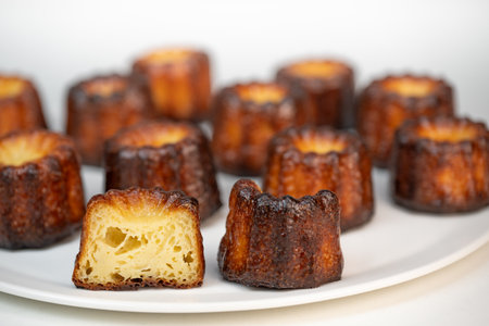 Canneles de bordeaux, traditional French sweet dessert with white table backgroundの写真素材