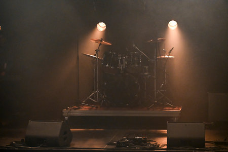 Exciting live concert atmosphere with dramatic lighting and eager audience anticipationの写真素材