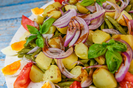 Fresh salad, green beans, small potatoes, egg, tomato, basil, red onions and balsamic vinaigretteの写真素材