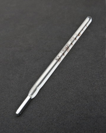 medical mercury thermometer on black