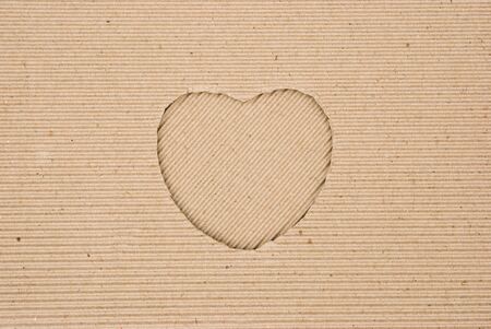 cardboard corrugated with a heart shape cut out, angledの写真素材