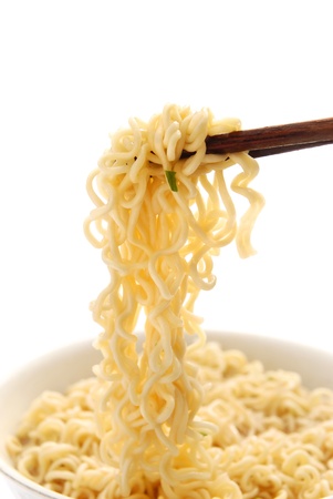 chopsticks holding oriental noodles on whiteの写真素材