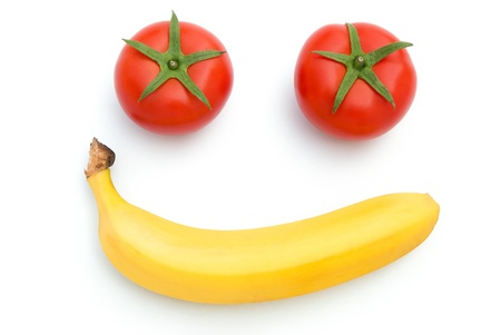 fresh tomatoes and carrot shape like smiling face の写真素材