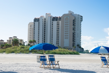 beach with deck chair near to buildings in a sunny morningのeditorial素材