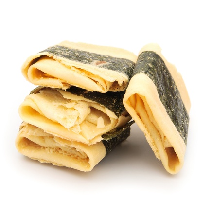 Chinese dessert on white, wrapped with seaweedの写真素材