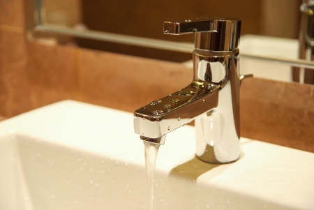 stainless steel water tap in a bath roomの写真素材