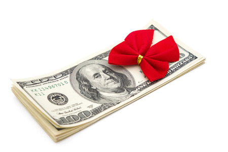 stack of dollars with red bow as giftの写真素材