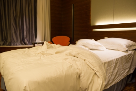 bed in a hotel roomの写真素材