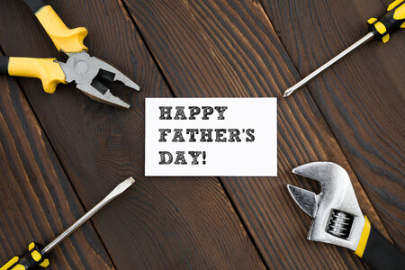 card of HAPPY FATHER'S DAY and tools on woodの写真素材