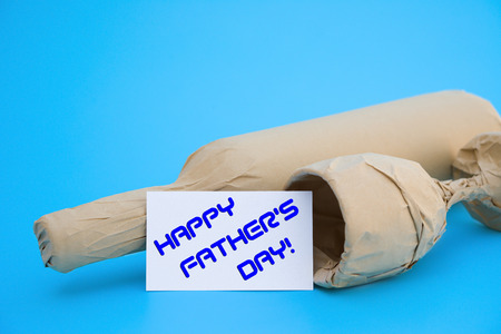 card of HAPPY FATHER'S DAY and wine and cup with copy spaceの写真素材