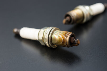 two used sparkplug on a black background