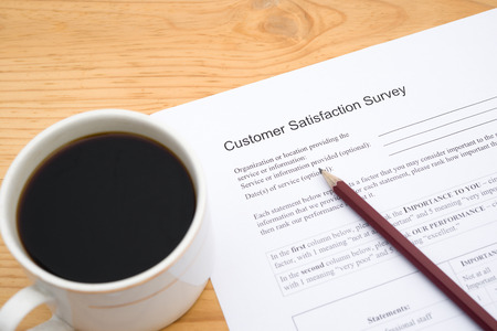 customer service satisfaction survey form and cup of coffeeの写真素材