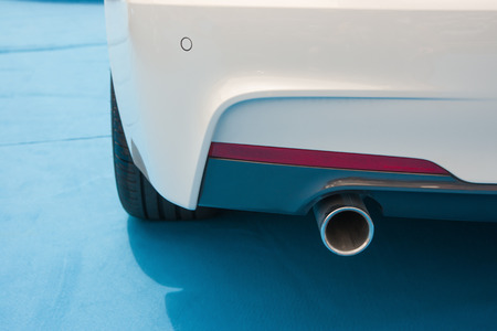 exhaust pipe of a white car on blue carpetの写真素材