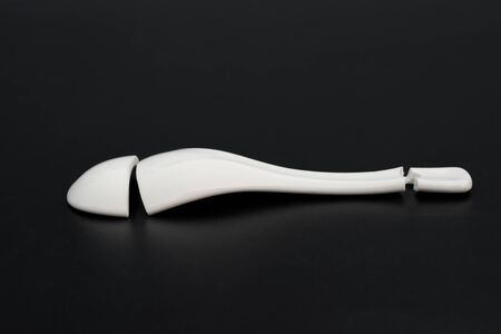 broken porcelain spoon on a black backgroundの写真素材