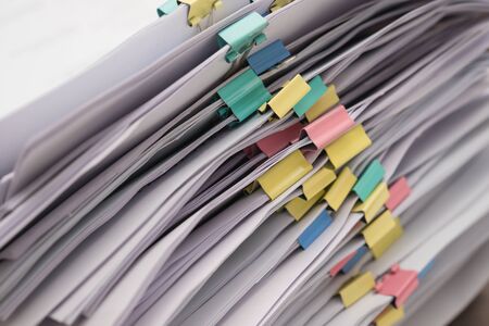 Pile of documents with colorful clips stack upの写真素材