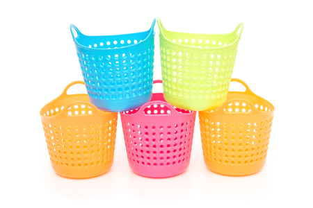 small and colorful baskets stack up on a white backgroundの写真素材