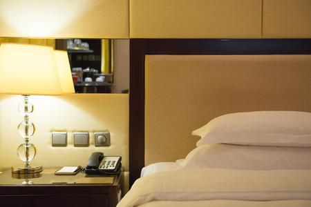 bed and lamp in a hotel roomのeditorial素材