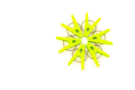 green clothespins line up as a circle on a white backgroundの写真素材